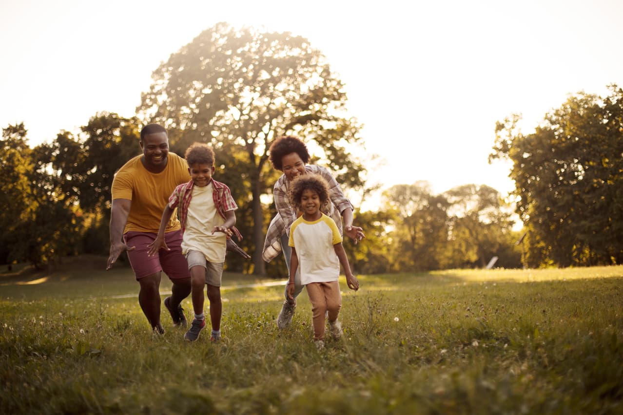 Two adults playing with their children